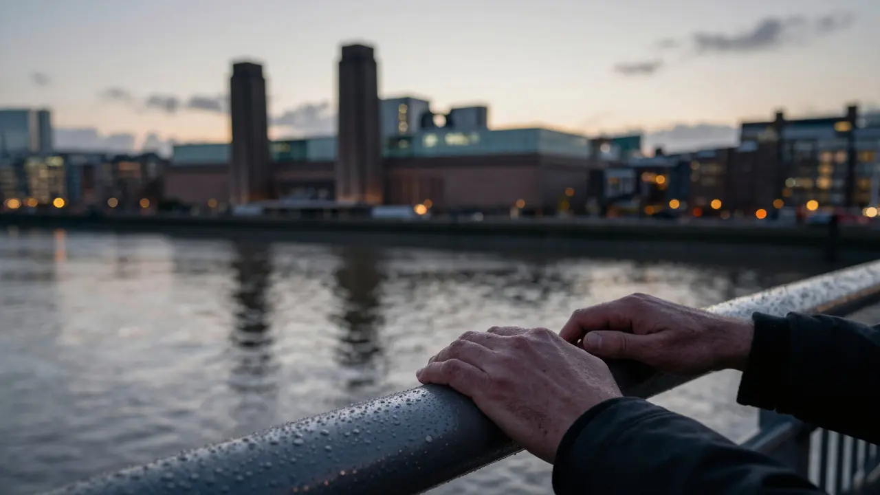 Hands resting on the railing of Southwark Bridge with reflections of the river and city lights.