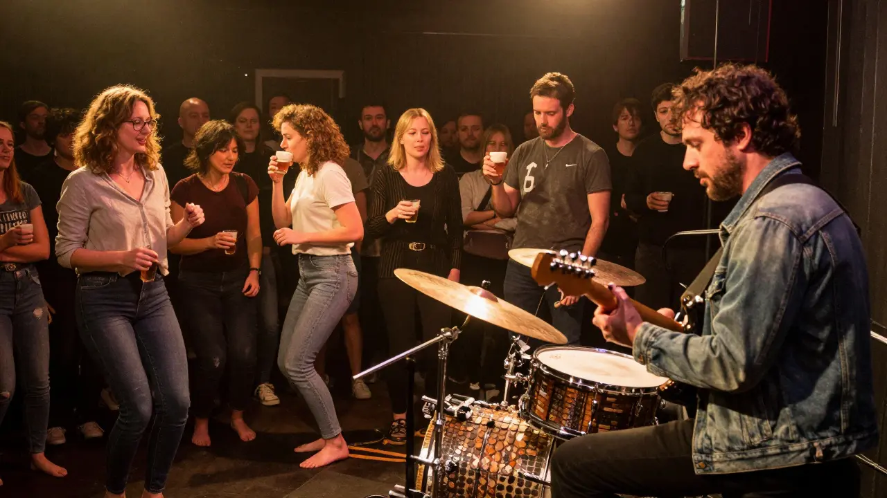 Diverse crowd gathered closely at a live music performance in a small Birmingham venue.